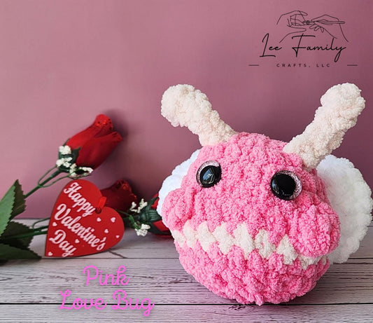 A pink colored Love Bug, crocheted stuffie.