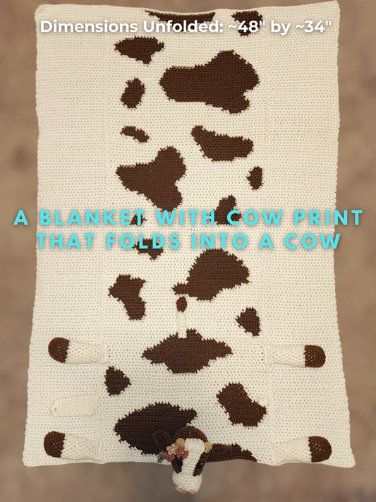 Full view of a handmade cow print baby blanket spread out for tummy time and floor play