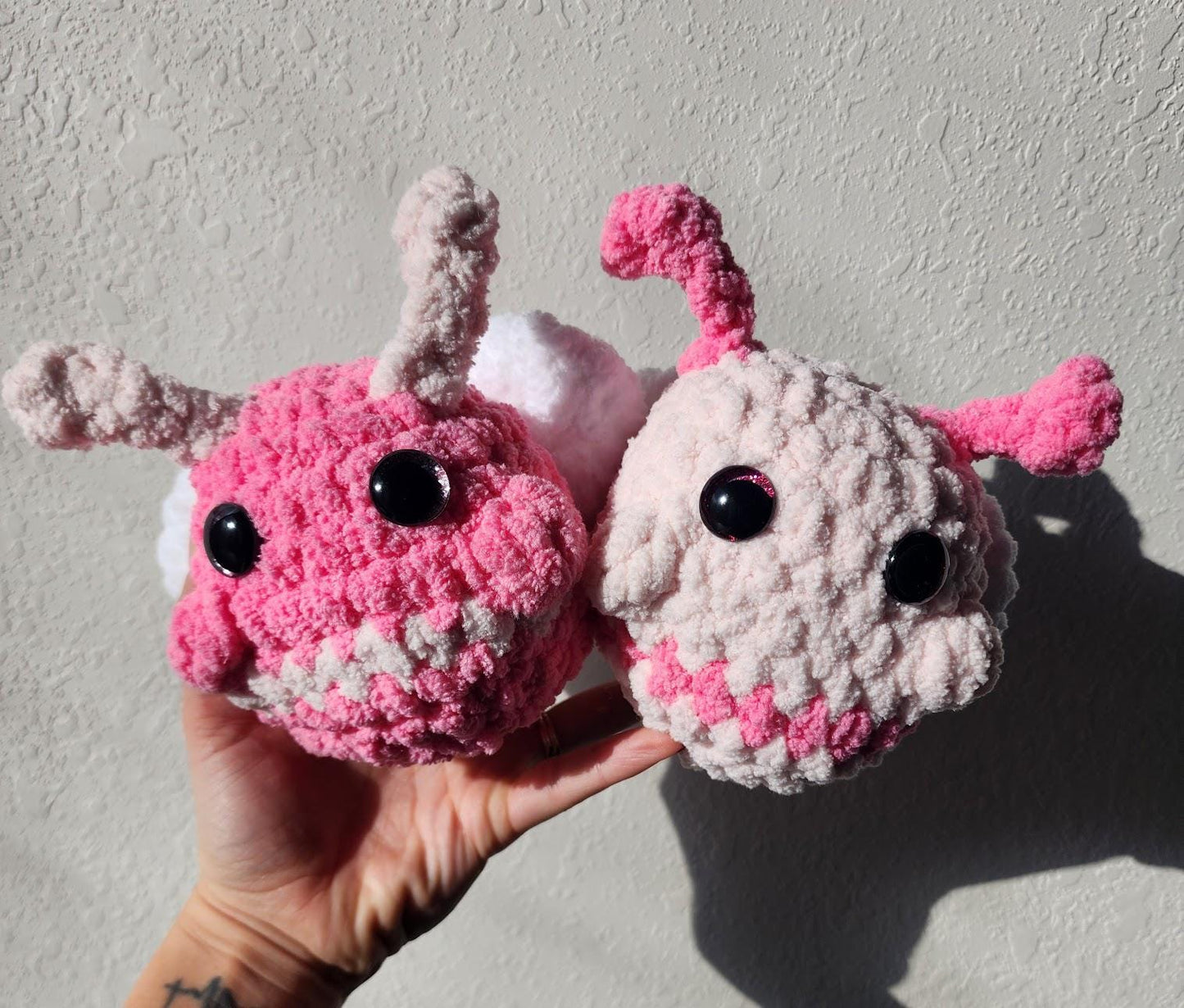 The Pink and Light Pink crocheted Love Bugs pictured together.